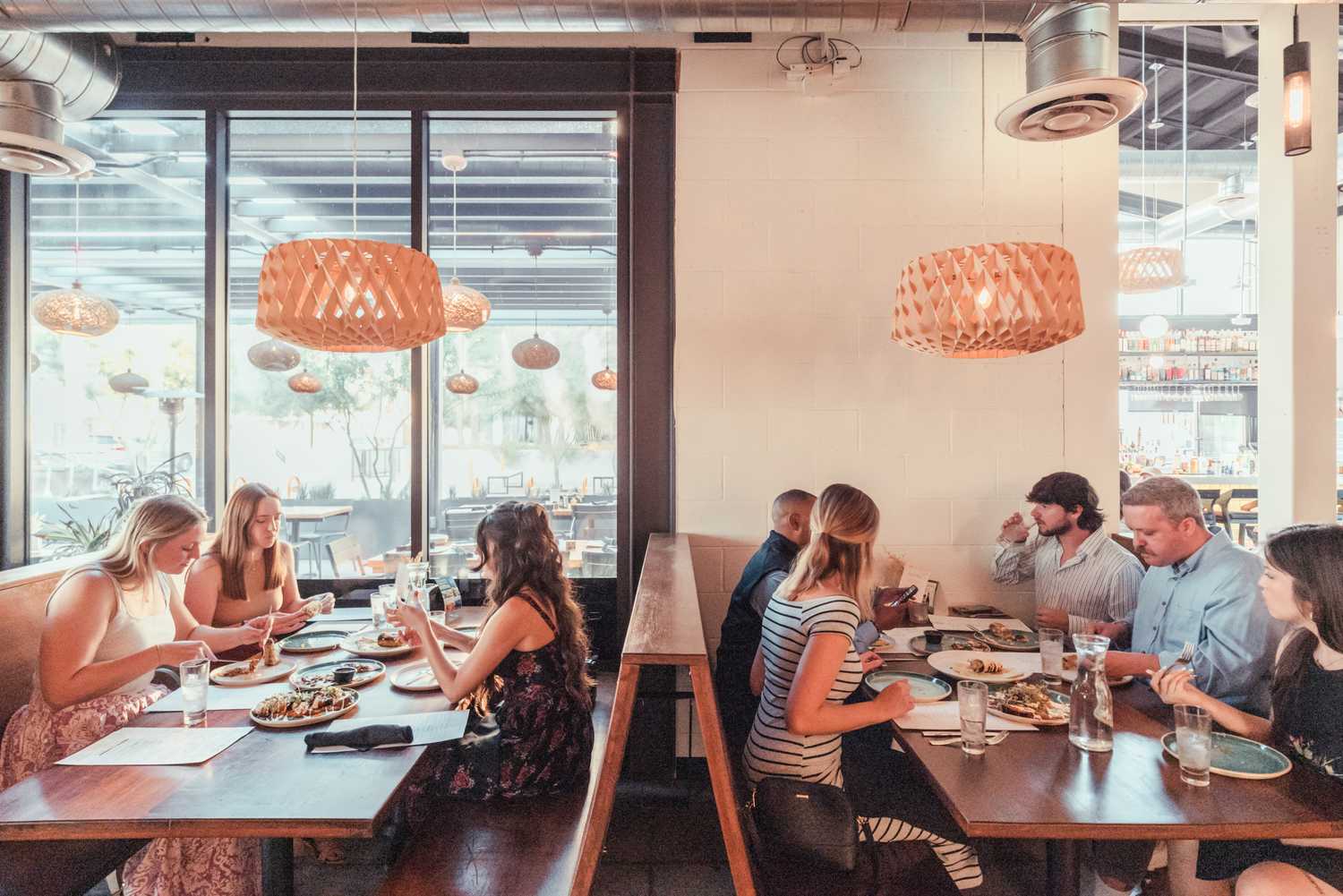 Guests eating at long wooden tables in a restaurant at Culdesac
